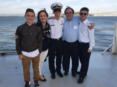 A picture of Ms. Frey and her family including three  sons and their father on the TS Golden Bear in the San Francisco Bay.